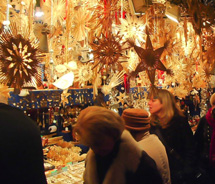Shoppers search for handmade decorations at a stall in the Nuremberg Christmas Market. // © 2011 Pride Travel / Nathan DePetris